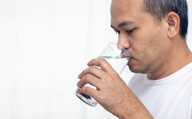 Asian men drink water in a glass