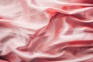 Smooth elegant pink silk or satin texture, abstract background luxury pink fabric with wavy folds