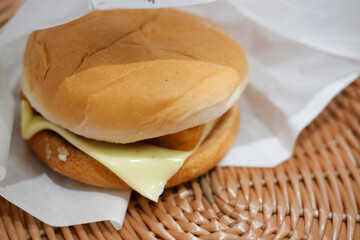 beef burger and french fries in a takeaway paper box on table 