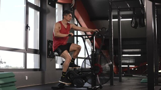  Mature Male Athlete Trains Cardio On Bike With Fan, Cardio And Endurance Training
