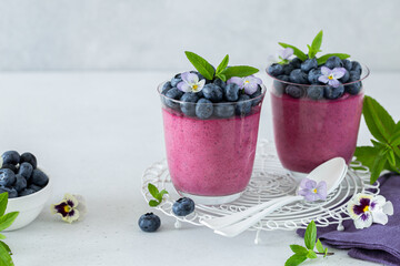 Blueberry dessert in glass, decorated with fresh berries