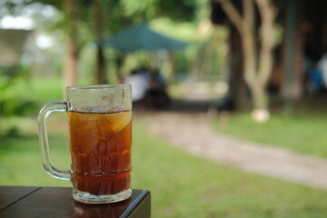 A glass of hot tea on a wooden table, copy space, background