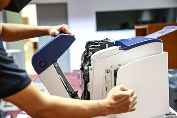 Technician hand open cover photocopier or photocopy to fix paper jam and replace ink cartridges for...