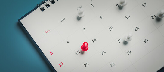 Embroidered red pins on a calendar event Planner calendar,clock to set timetable organize schedule,planning for business meeting or travel planning concept.