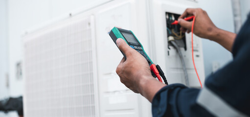 Air conditioner technicians use a multimeter to check electricity and Part of the preparation to install a new air conditioner.