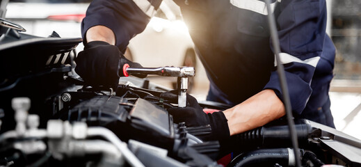 Car care maintenance and servicing, Close-up hand technician auto mechanic using the wrench to repairing change spare part car engine problem and insurance service support.