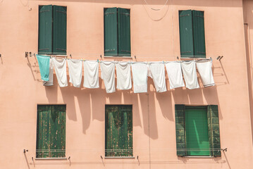 Clothes drying in the window in Italy.