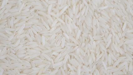 organic white raw jasmine- basmati rice background, white long seeds. macro closeup. as picture backdrop or background pattern texture