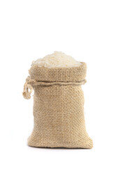 White organic raw jasmine rice in burlap sack bag isolated on white background