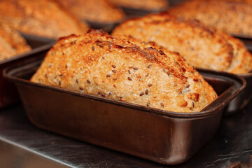 freshly baked bread in molds on the table in bakery