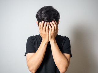 Depressed man hold his face  feels hopeless white background