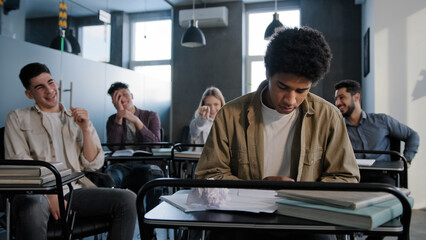 Unhappy african american student loser feeling mocking bullying anger from classmates suffering...