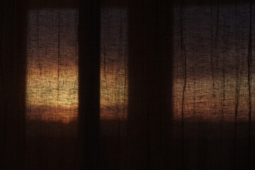 Window curtains in sunset light dark interior - obrazy, fototapety, plakaty