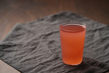 Organic guava drink in thin glass on wood table
