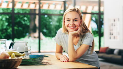Portrait of Beautiful Young Adult Woman with Blond Hair Wearing Gray V-Neck T-Shirt, Leaning on a...