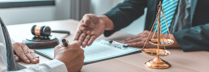 Lawyer or judge has recommend a client sign a legal agreement in the courtroom, Legal Agreement Documents and Business Litigation Forms, scales of justice, law hammer, Litigation and legal services.