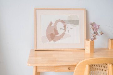 Portrait white picture frame mockup on wooden table. Modern ceramic vase with eucalyptus. White...