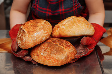 baker holding in hands a bunch of fresh bread