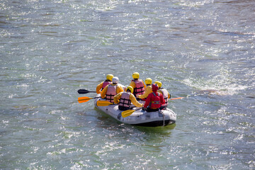 rafting boat colors people rowing in Arahthos river Arta Greece