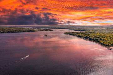 Penetanguishene Ariel drone shot during sunset  with boats in the lake and the clouds reflecting on...