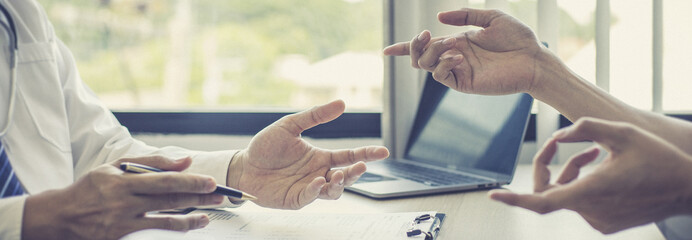 Male doctor made a diagnosis on a male patient and gave advice on treatment methods in the hospital examination room, Helping patients with medical advice, Health care counseling.