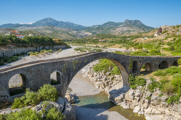 Fototapeta na wymiar The Old Ottoman Mesi Bridge on the Kir river, Shkoder, Albania