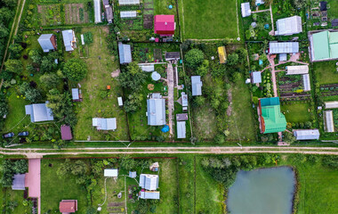 Aerial drone tope view on private houses and gardens in the countryside.  Contryhouse top view. Summer leisure time. Garden trees.