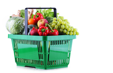 Fresh organic fruits and vegetables in plastic shopping basket