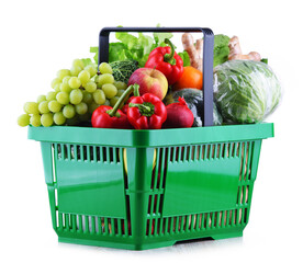 Fresh organic fruits and vegetables in plastic shopping basket