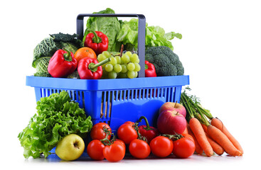 Fresh organic fruits and vegetables in plastic shopping basket