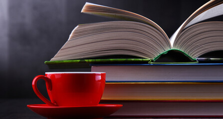 Naklejka premium Composition with books and cup of coffee on the table