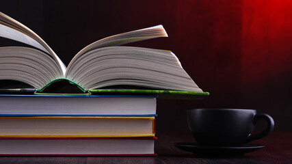 Composition with books and cup of coffee on the table