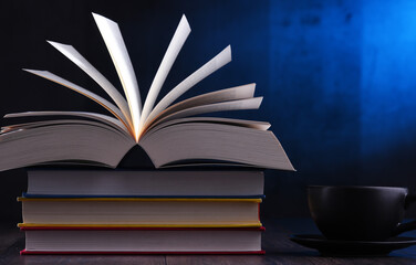 Composition with books and cup of coffee on the table