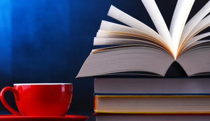 Composition with books and cup of coffee on the table