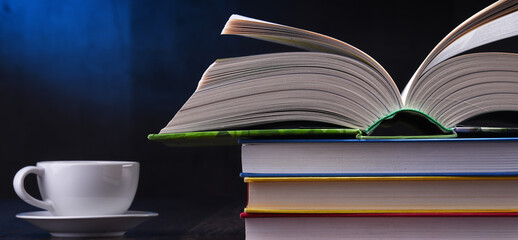 Composition with books and cup of coffee on the table