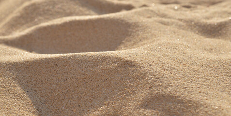 Fototapeta na wymiar Background of yellow clean sand on the beach close-up