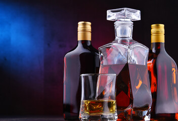 Carafe and bottles of assorted alcoholic beverages