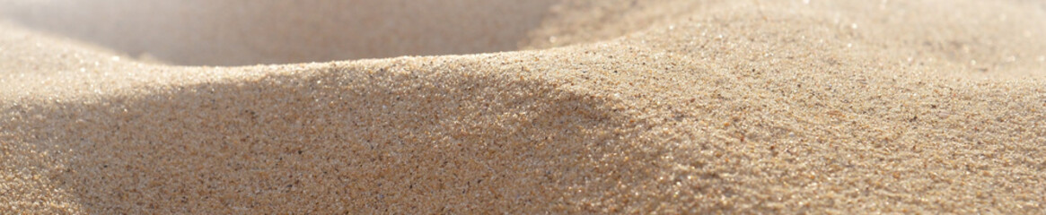 Background of yellow clean sand on the beach close-up