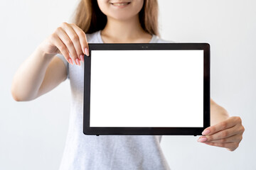 Online education. Digital information. Advertising mockup. Unrecognizable woman holding in hands tablet computer with blank screen isolated white.