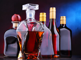 Carafe and bottles of assorted alcoholic beverages