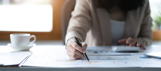 Close up of Business woman investment consultant analysis company annual financial report balance...