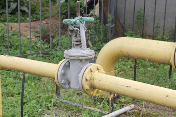Shut-off valve on gas pipe. Fragment of pipeline with valve. Valve on pipe in boiler room. Concept...