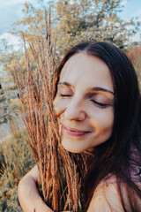 beautiful woman embraces ears of barley or wheat. Harvest, agriculture concept