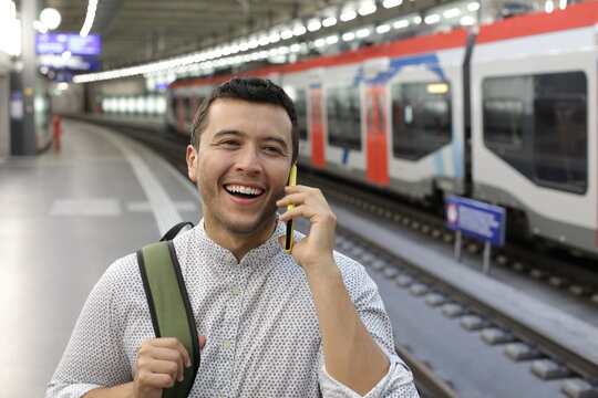 Man using cellphone in train station 