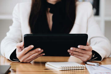 business woman using a tablet computer for data analysis, marketing, accounting