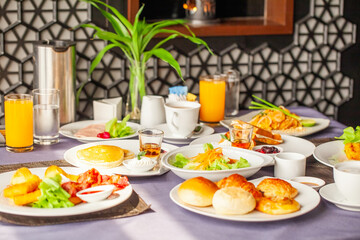 Concept of weekend vacation, rest on holiday in modern city hotel. Dinner or lunch in cafe in resort. Food and drinks served on table for two persons on breakfast or brunch at morning in restaurant.