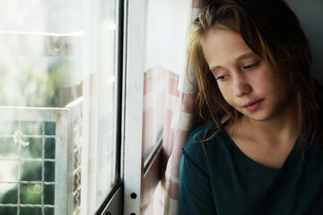 Portrait of a teenager girl at home near the window - 517535285