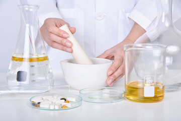 Scientist mixing vitamin supplement, Pills and scientific laboratory glassware, Medicine research...