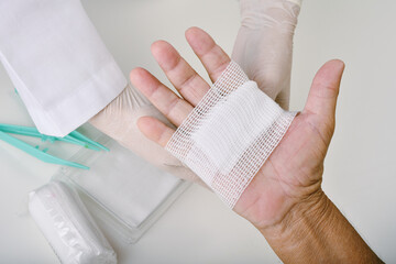 Doctor doing wound dressing care and bandaging patient's hand, Hand surgery treatment, Nurse treat...
