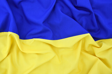 Fabric bent national flag of Ukraine, UA.